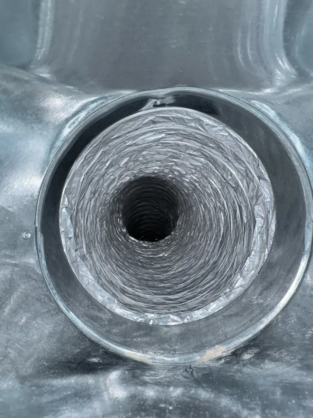 Clean flex duct run photographed face on inside its collar