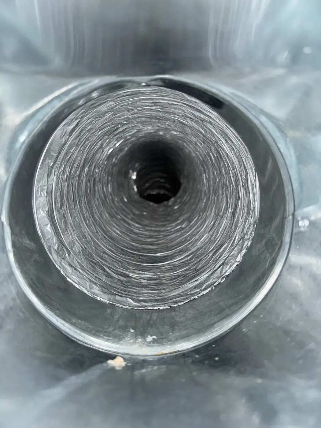 Close view of a cleaned flex duct spiral in an Omaha home